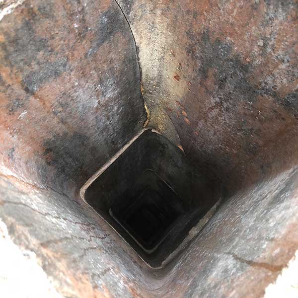 Inside view of chimney flue with cracked flue tiles