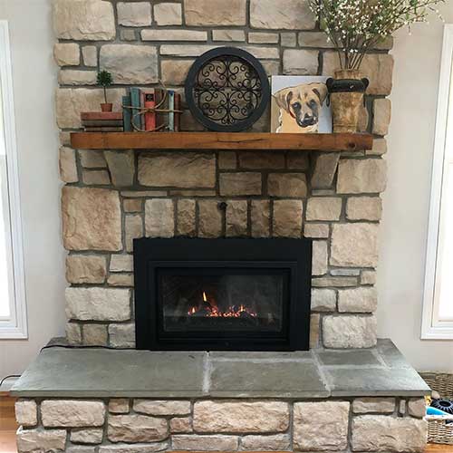 Fireplace with Gas Insert and stone surround, hearth, and wood mantel