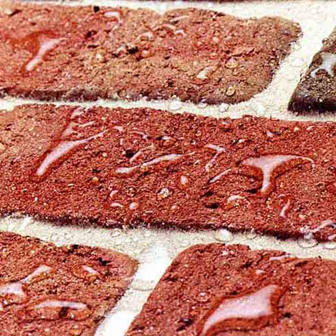 Close up of bricks with water droplets repelling on the surface