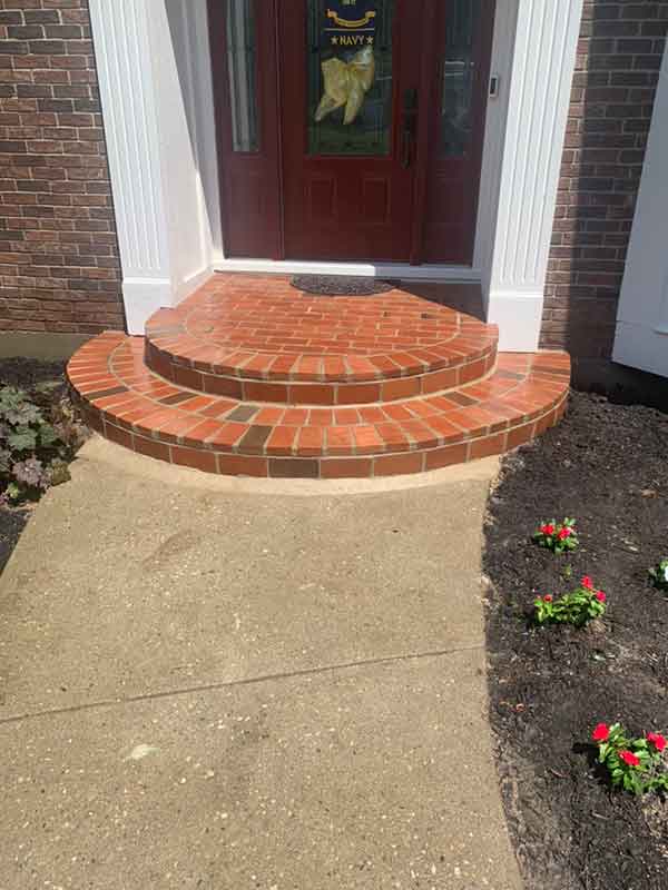 Brick entryway steps after Complete grindout retuckpoint 