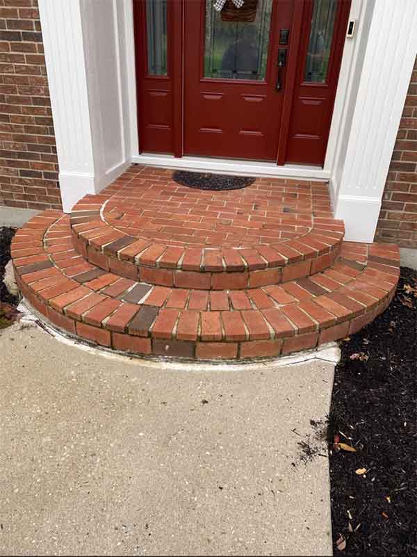 Brick entryway steps before Complete grindout retuckpoint 