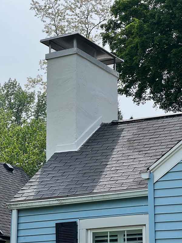 Chimney repairs after showing new stucco, chimney crown and stainless steel chimney cap