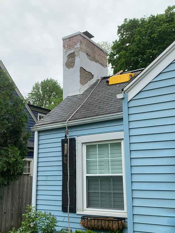 Chimney repair before repair with Damaged Stucco and Crown