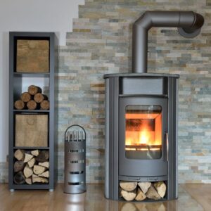 metal wood-burning stove with a wood pile next to it